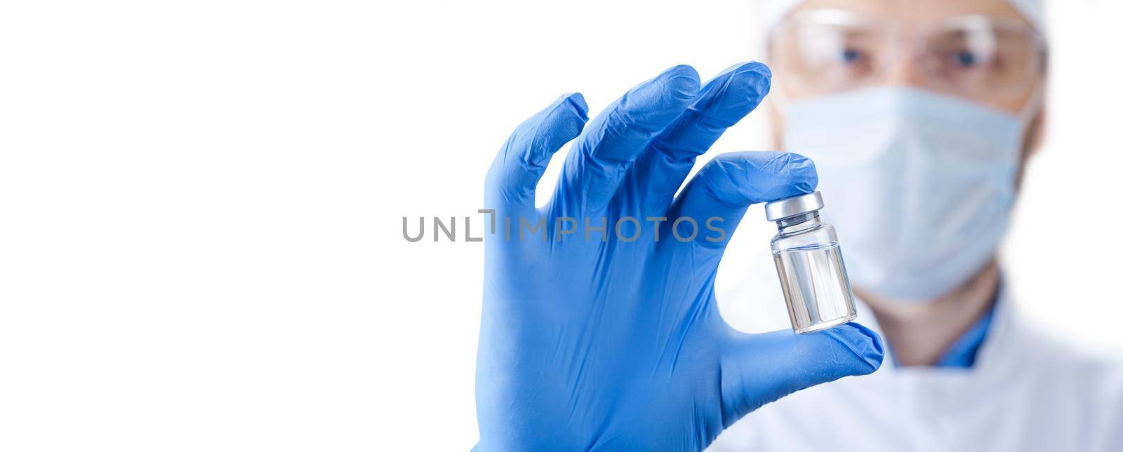 Doctor holding a viol with vaccine against corona virus. by Taut