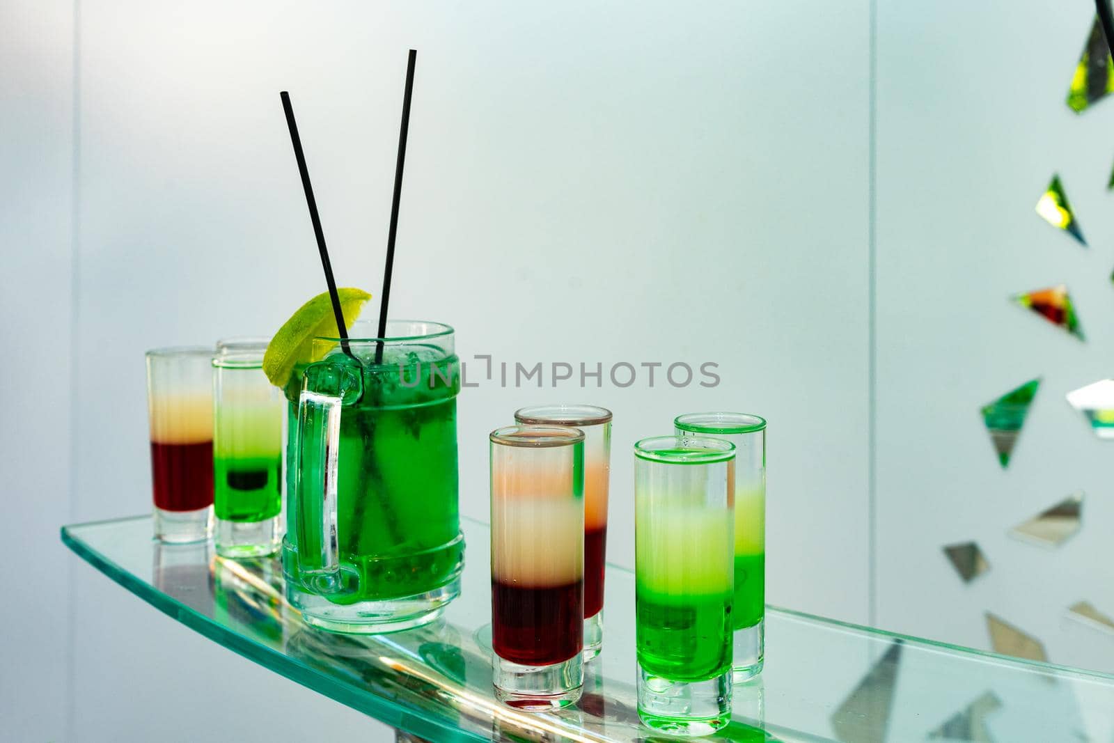 Green cocktail with lemon. Multicolored summer cocktails. Refreshing drinks.