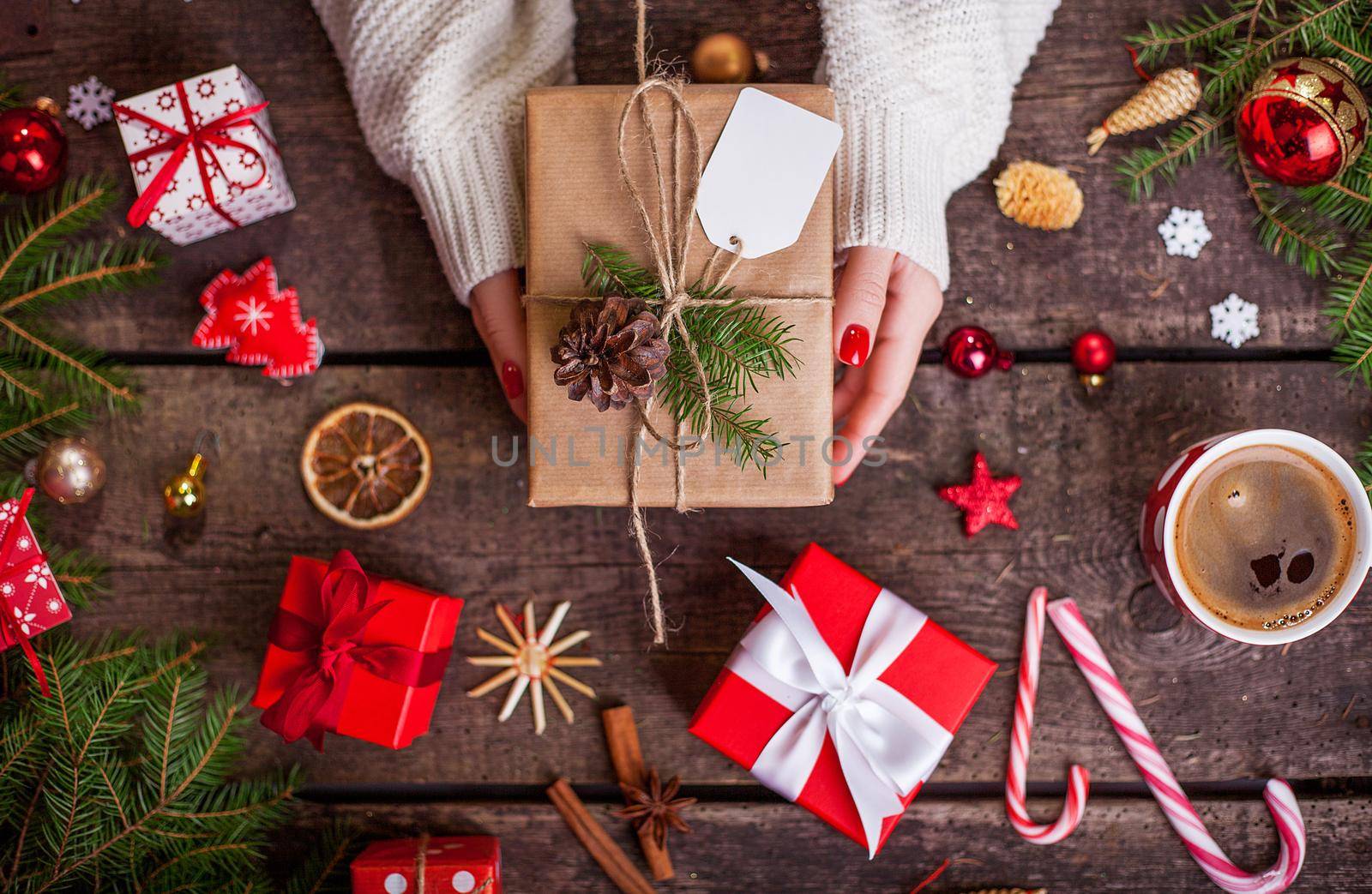 Gift box in wrapping paper with satin ribbon. Merry Christmas holiday concept.