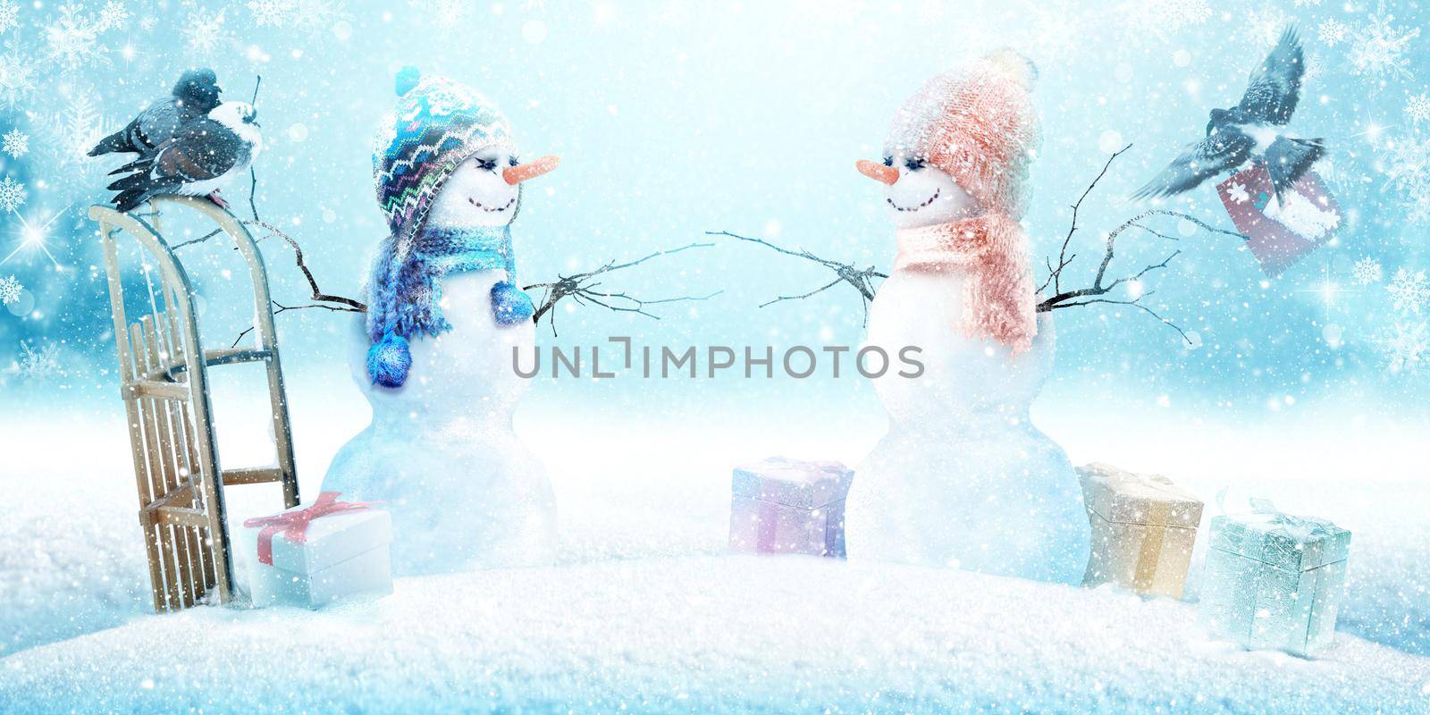 Happy snowman standing in winter christmas landscape.