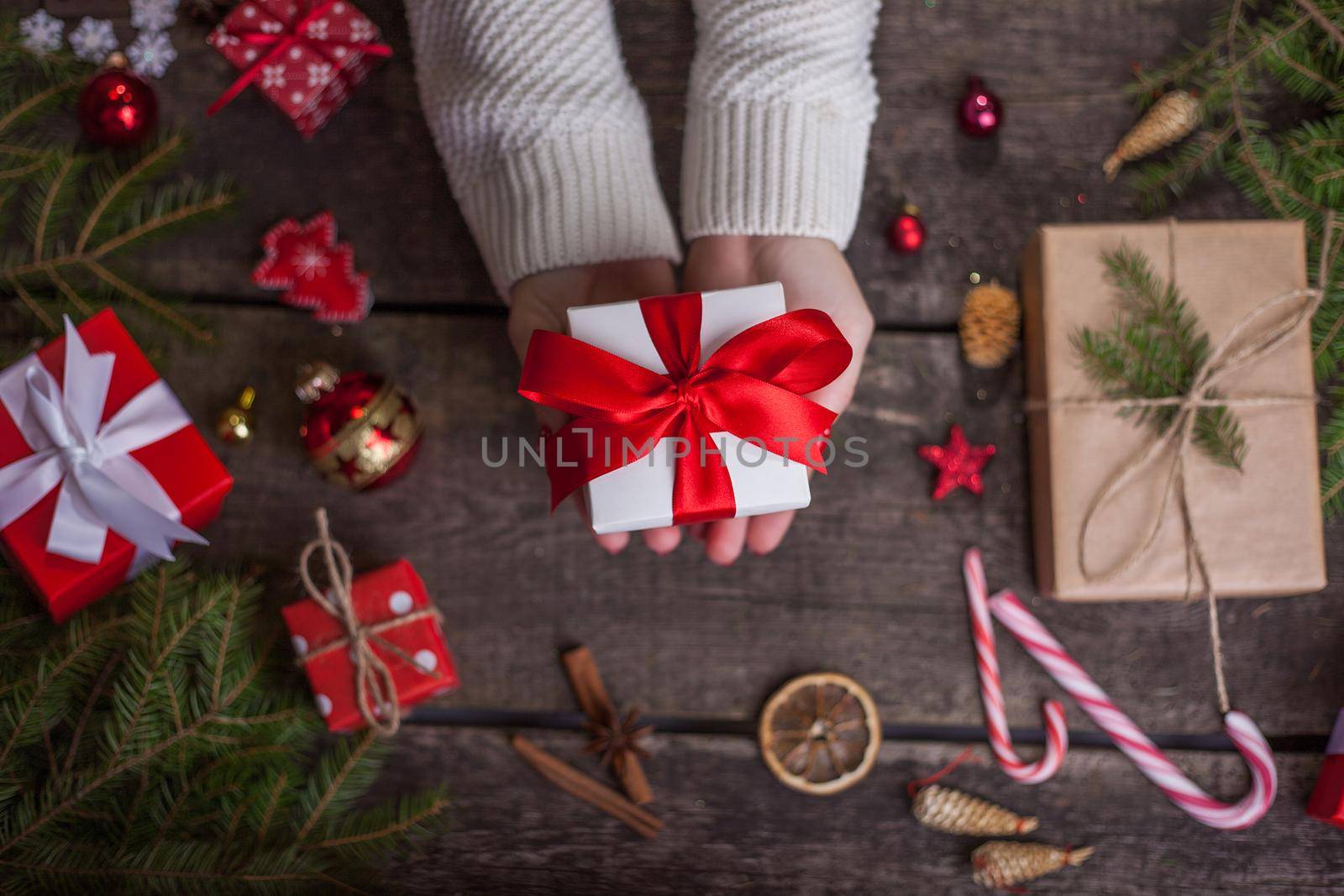 Gift box in wrapping paper with satin ribbon. Merry Christmas holiday concept.