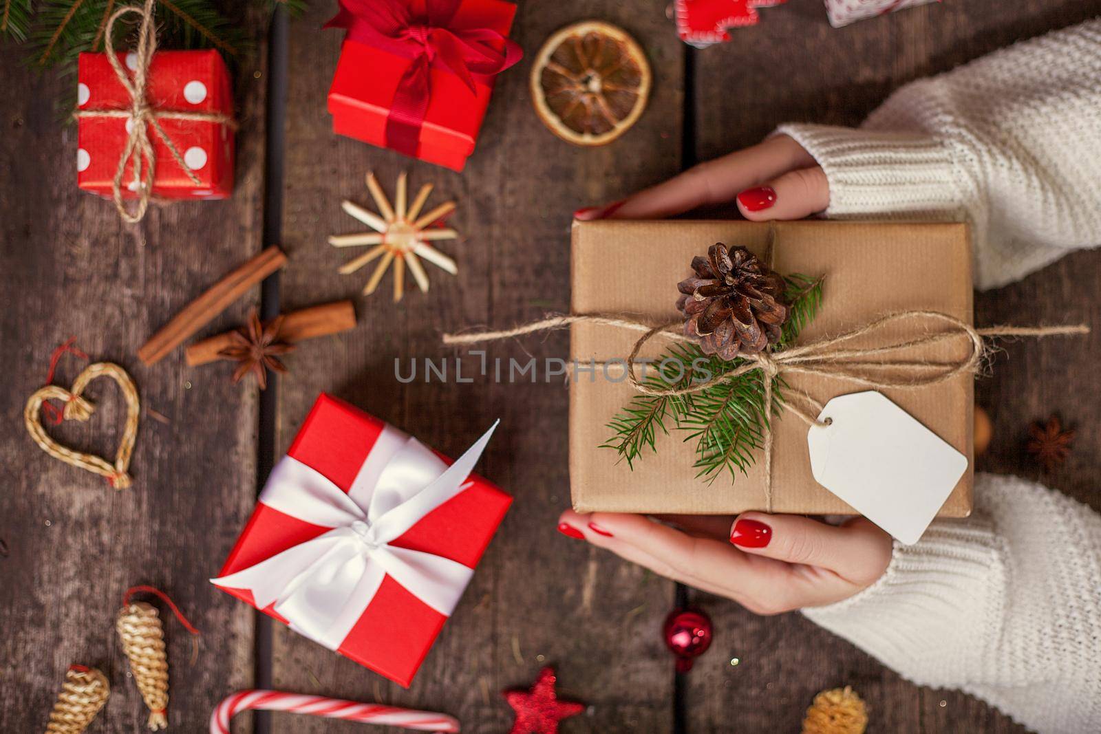 Gift box in wrapping paper with satin ribbon. Merry Christmas holiday concept.