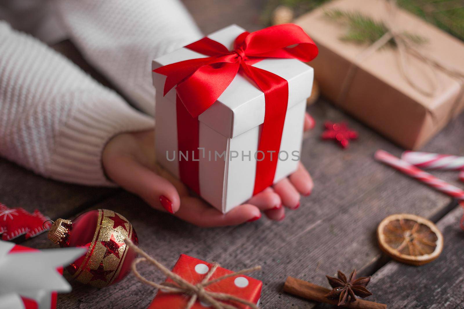 Gift box in wrapping paper with satin ribbon. Merry Christmas holiday concept.