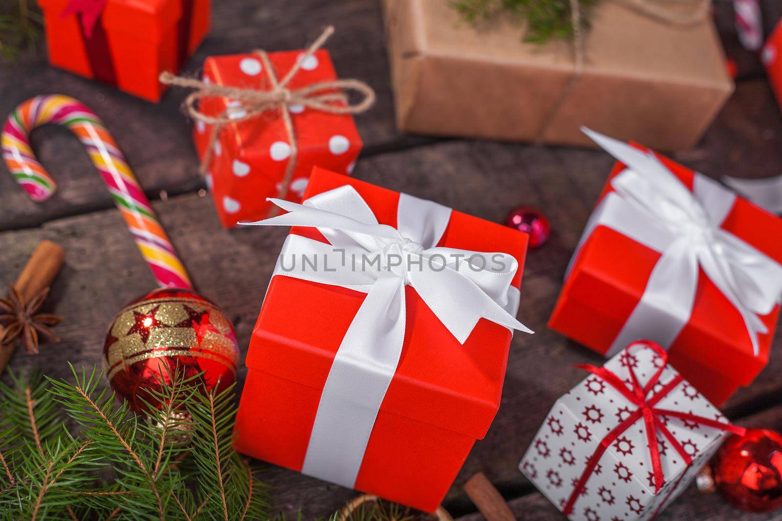 Gift box in wrapping paper with satin ribbon. Merry Christmas holiday concept.