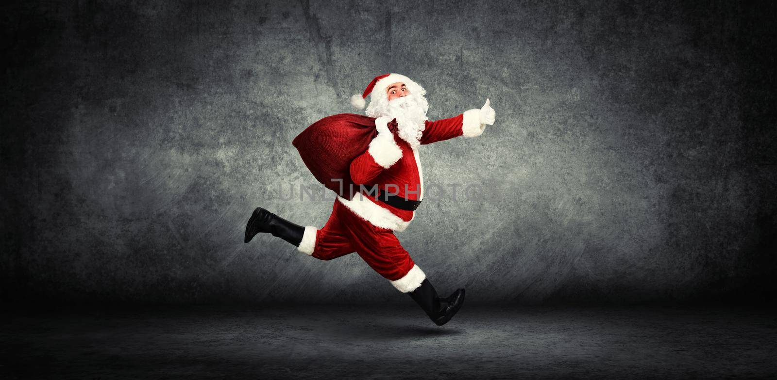 Santa Claus with a bag full of presents by Taut
