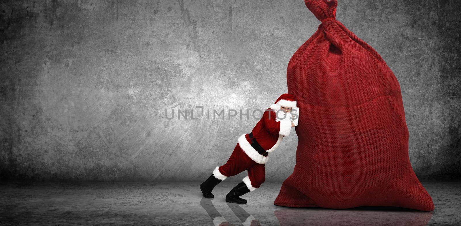 Santa Claus with a bag full of presents by Taut