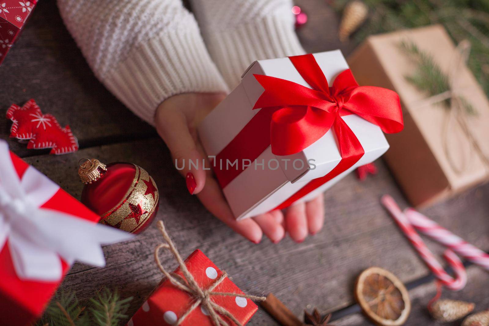 Gift box in wrapping paper with satin ribbon. Merry Christmas holiday concept.