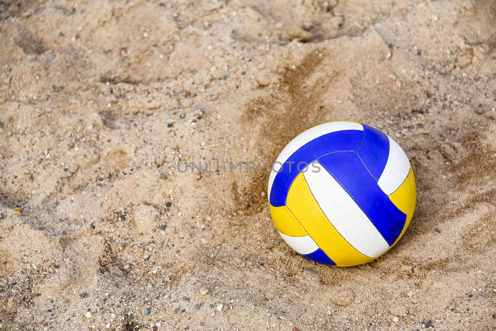 Voleyball on the beach. Collored Ball on the pebble. Close-up. copy space. Summer beach game.