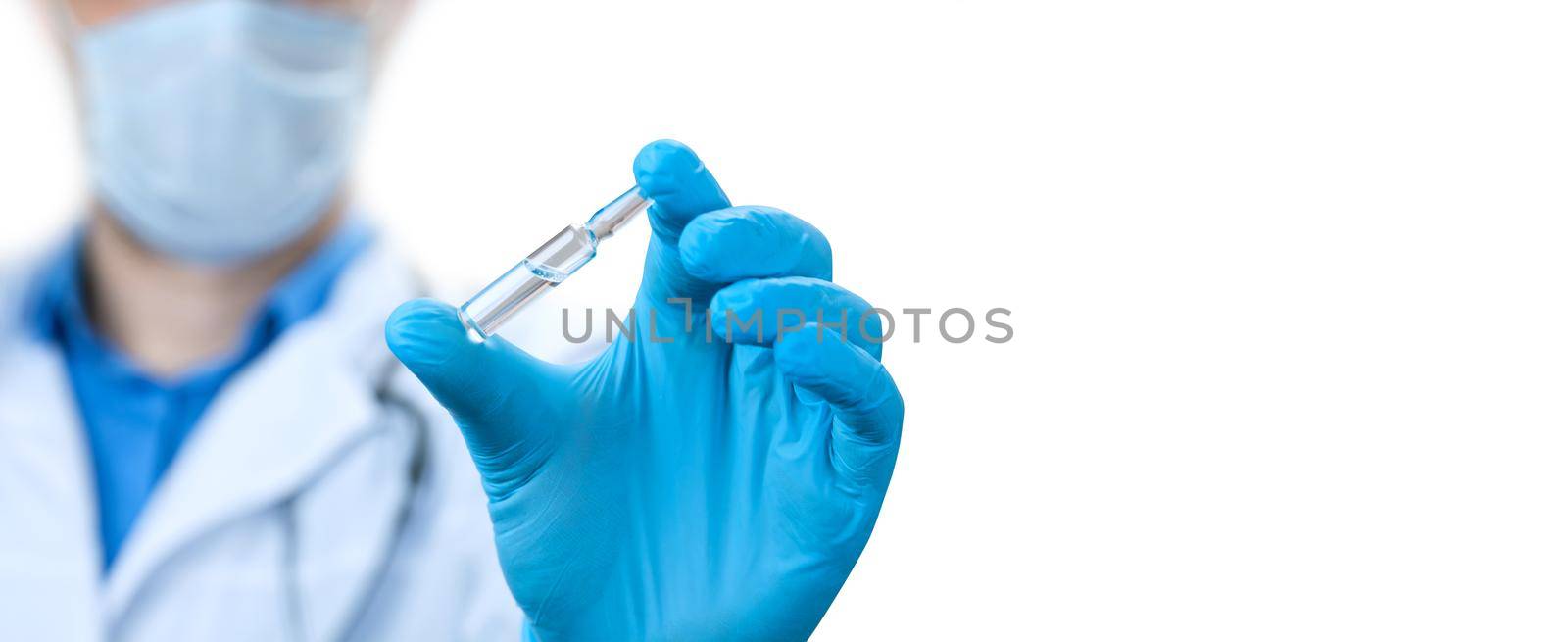 Doctor holding a viol with vaccine against corona virus. by Taut