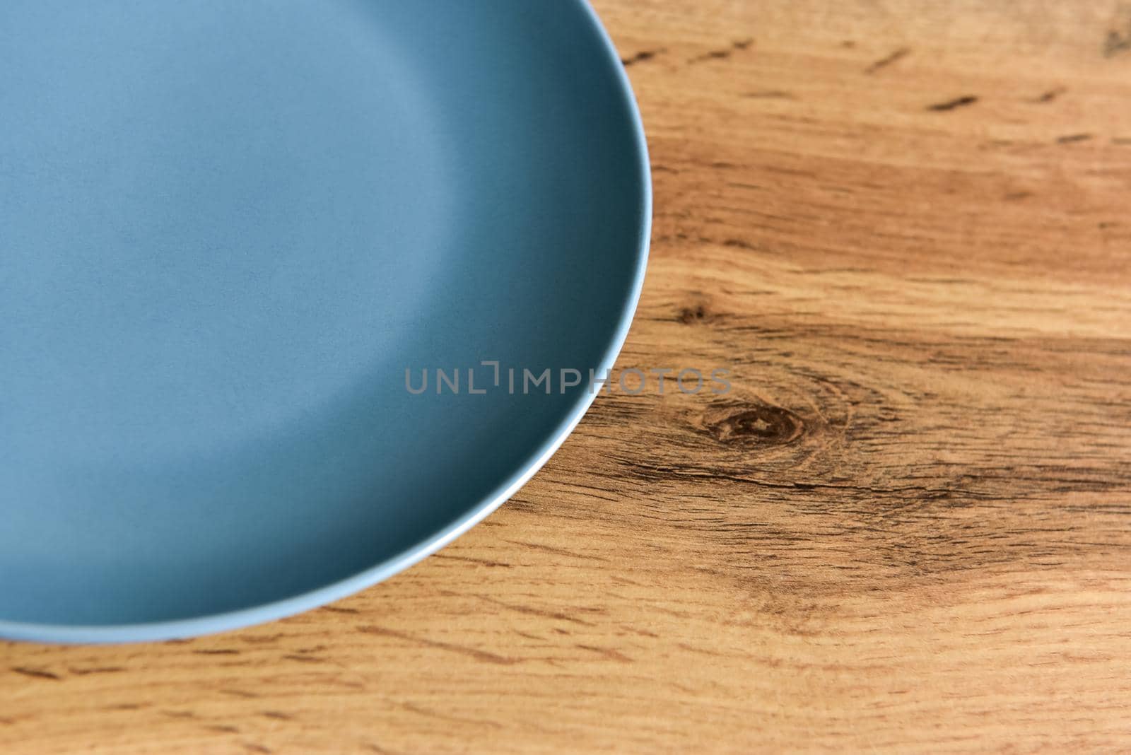 Close-up of empty plate on wooden background with copy space.