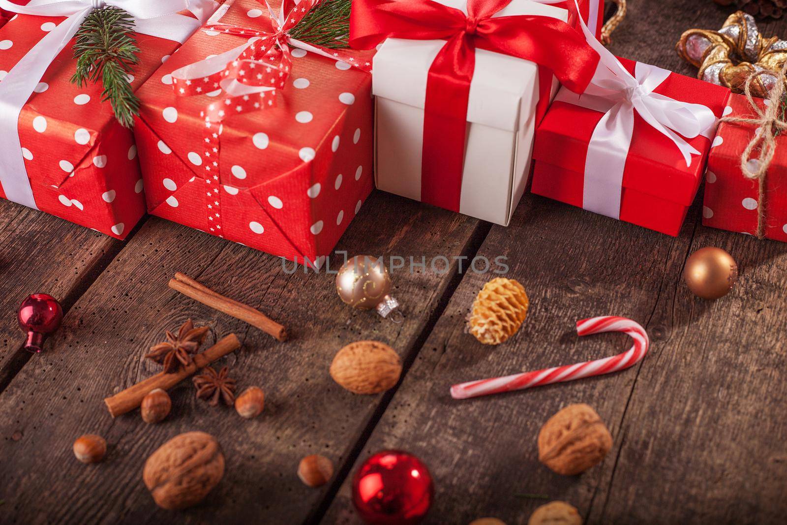 Gift box in wrapping paper with satin ribbon. Merry Christmas holiday concept.
