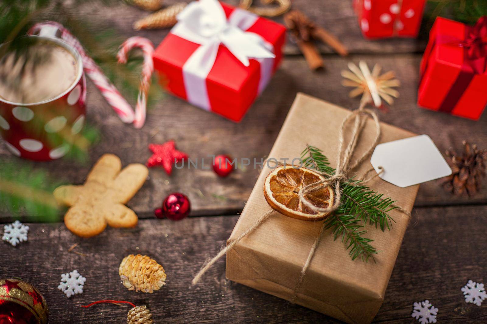 Gift box in wrapping paper with satin ribbon. Merry Christmas holiday concept.