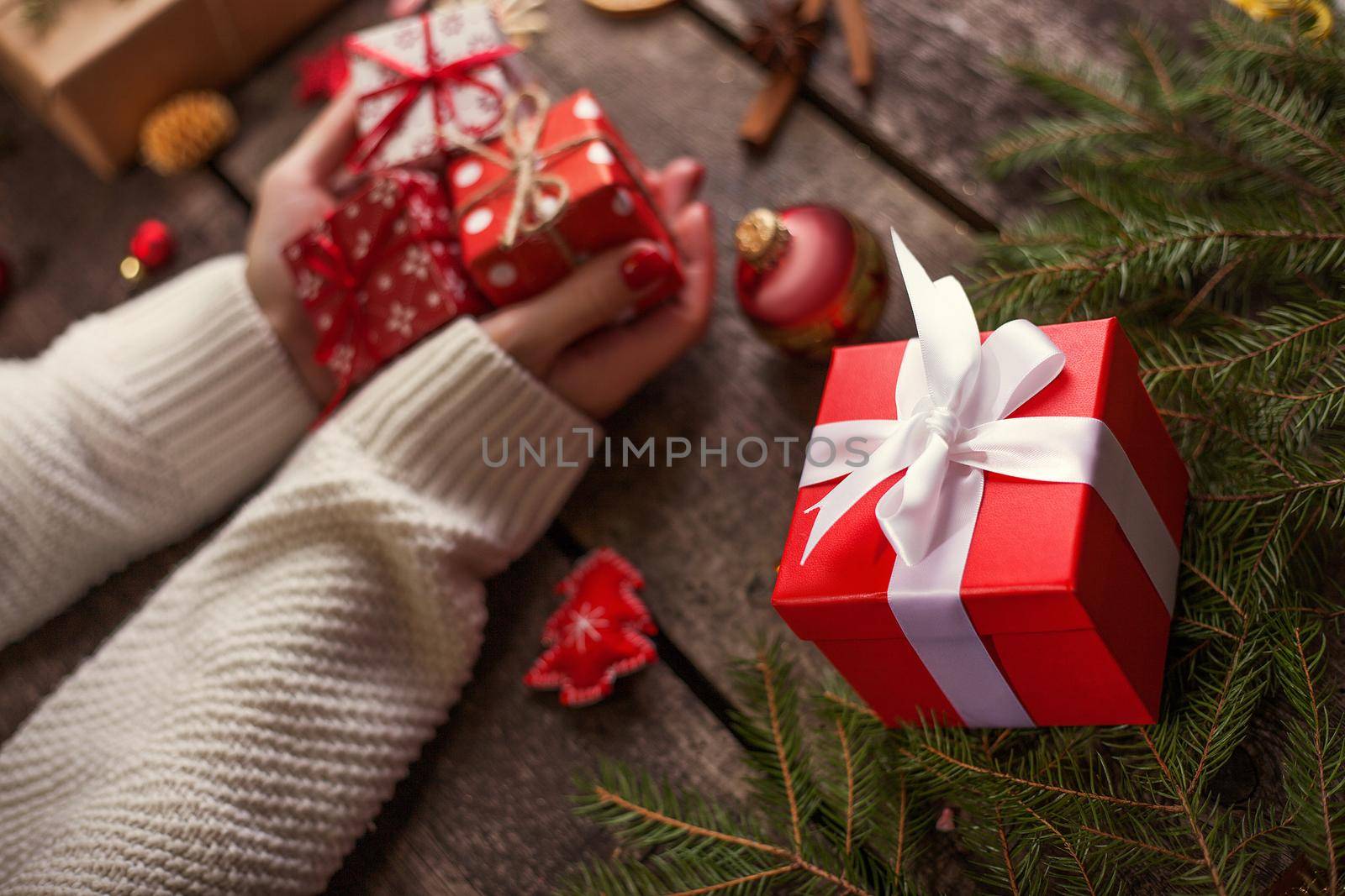Gift box in wrapping paper with satin ribbon. Merry Christmas holiday concept.