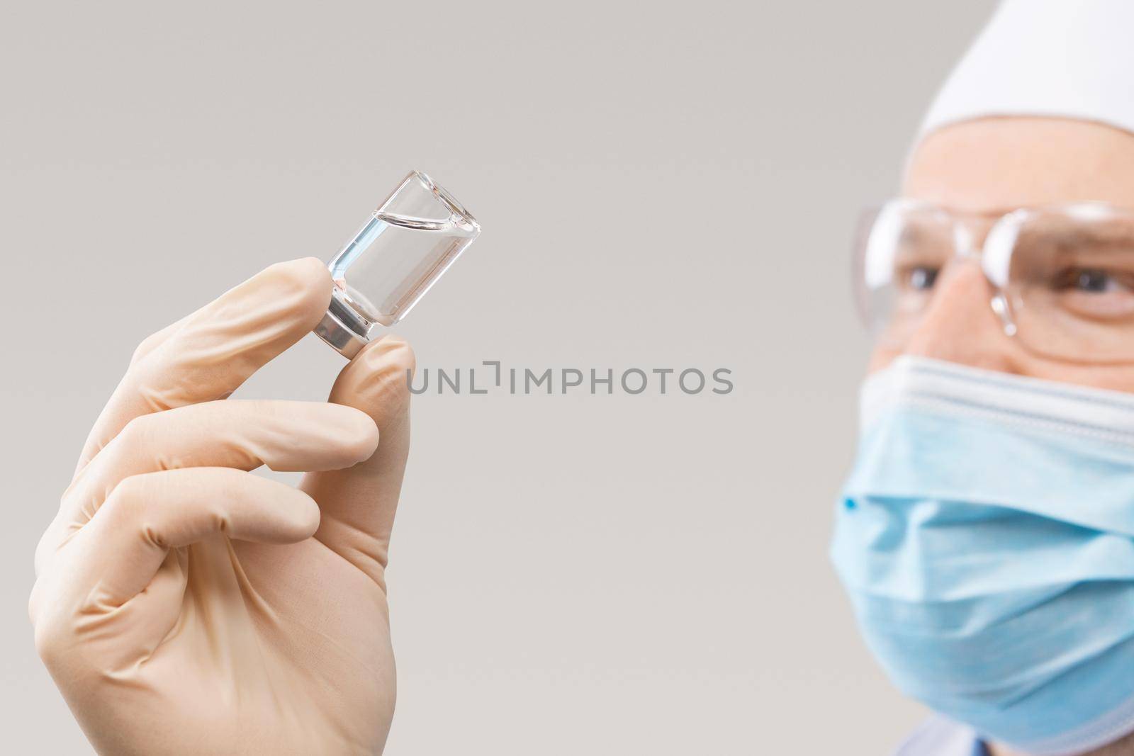 Doctor holding a viol with vaccine against corona virus. by Taut