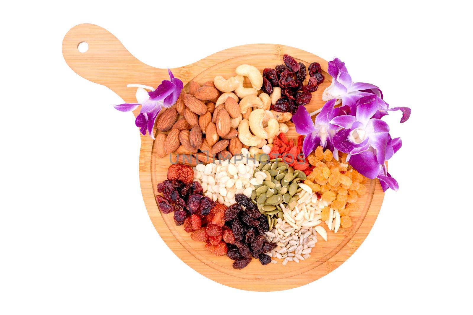 Top view group of whole grains and dried fruit with beautiful orc hid on a wooden plate isolated on white background.