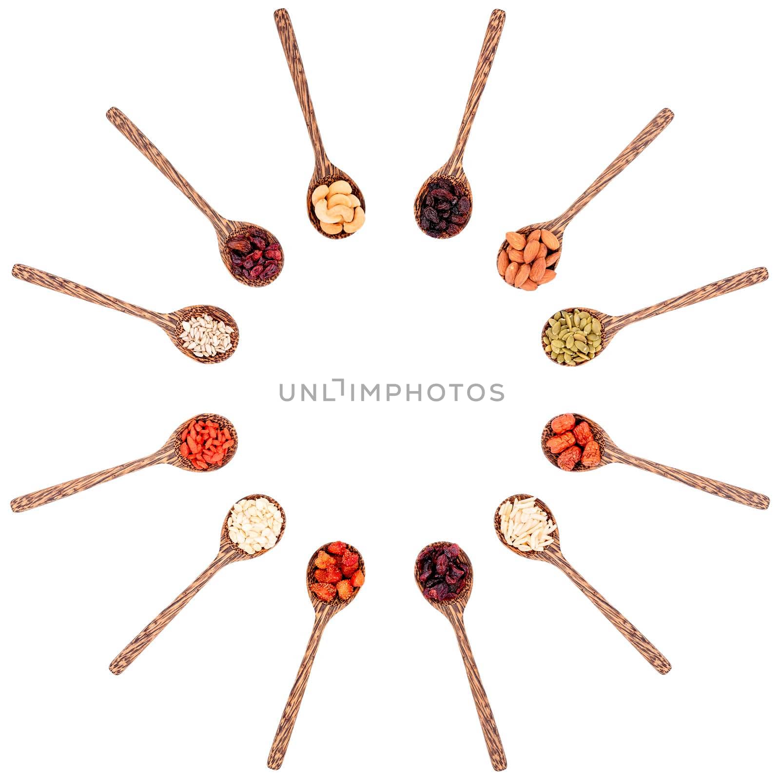 Top view group of various types of dried fruits on a wooden spoon isolated on white background. by wattanaphob