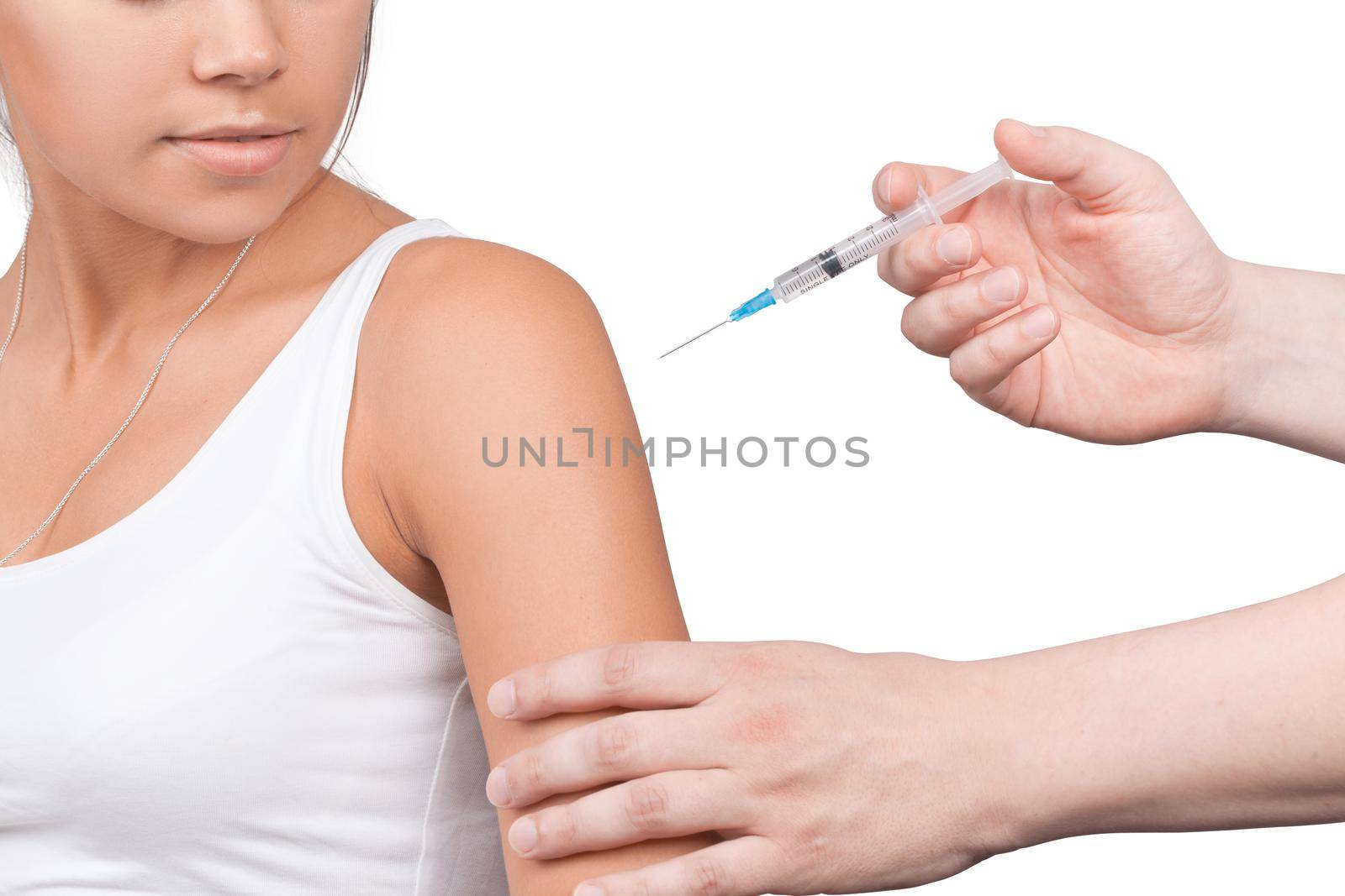 Doctor gives a syringe with vaccine to patient at clinic. by Taut