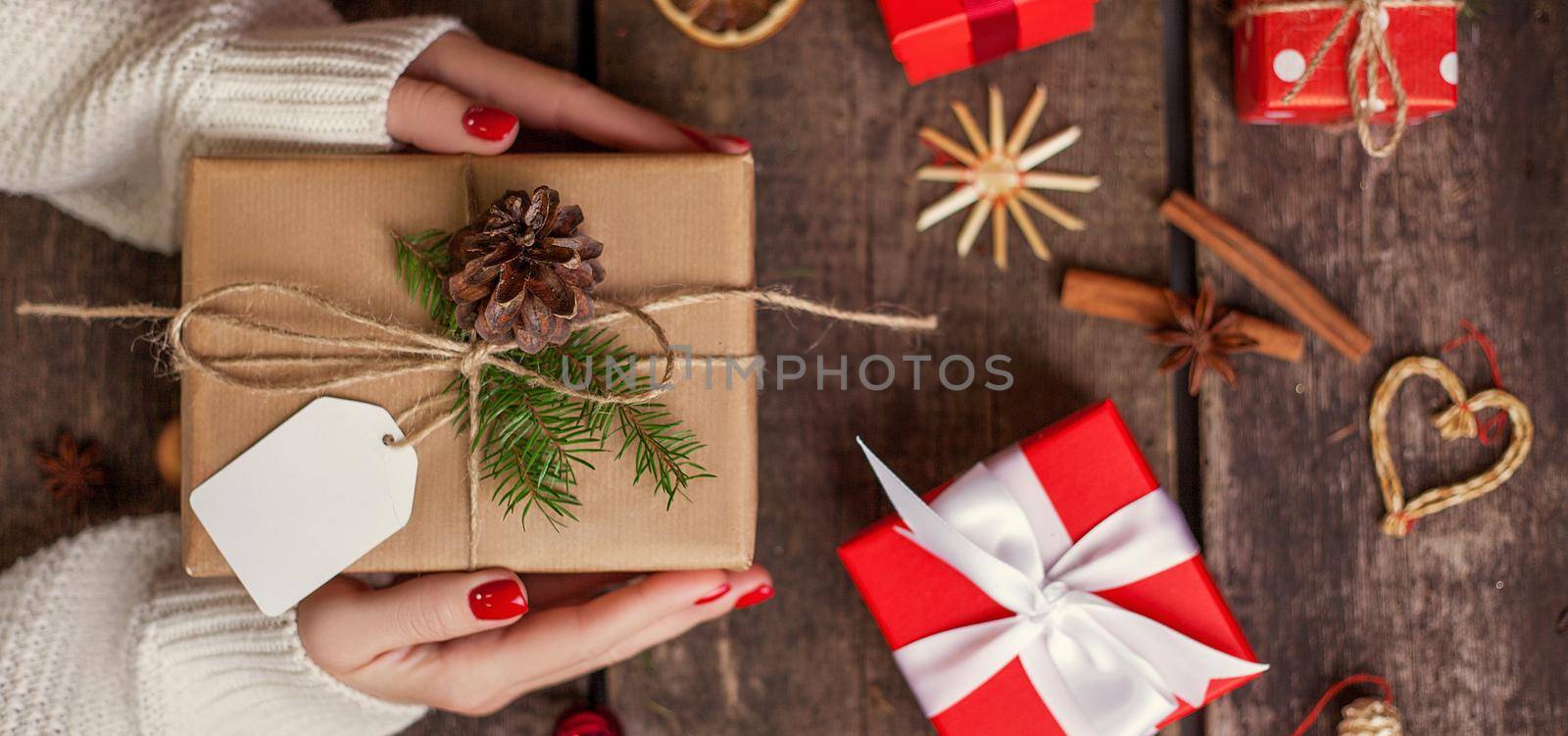 Gift box in wrapping paper with satin ribbon. Merry Christmas holiday concept.