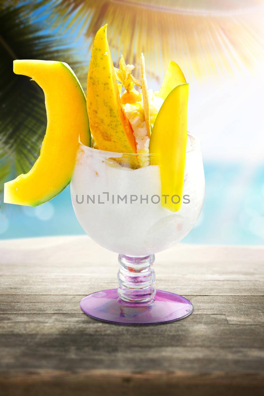 Delicious ice cream on the beach. Healthy summer food concept. by Taut