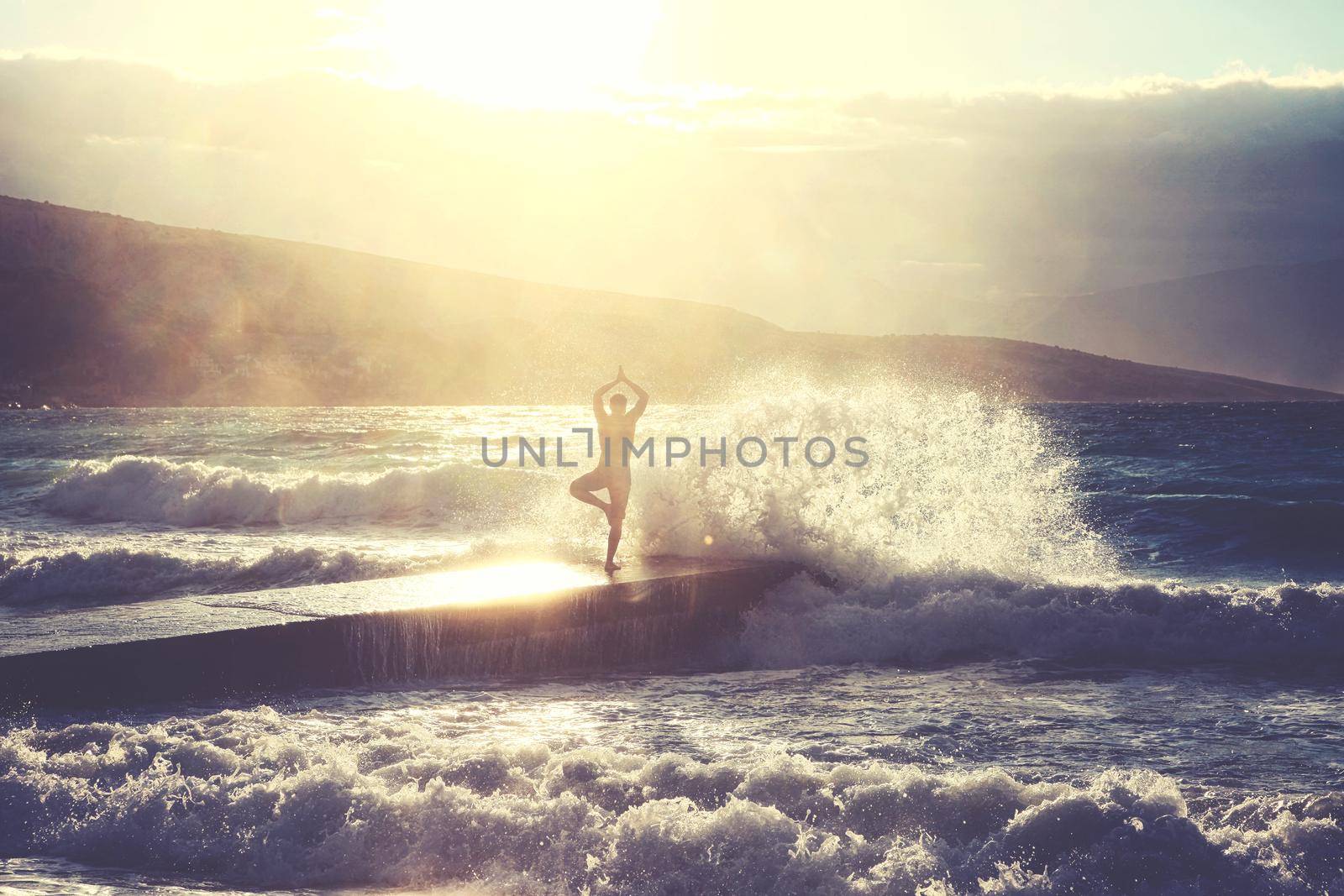 Feeling of freedom concept. Man standing on pier facing to the sea with big waves.