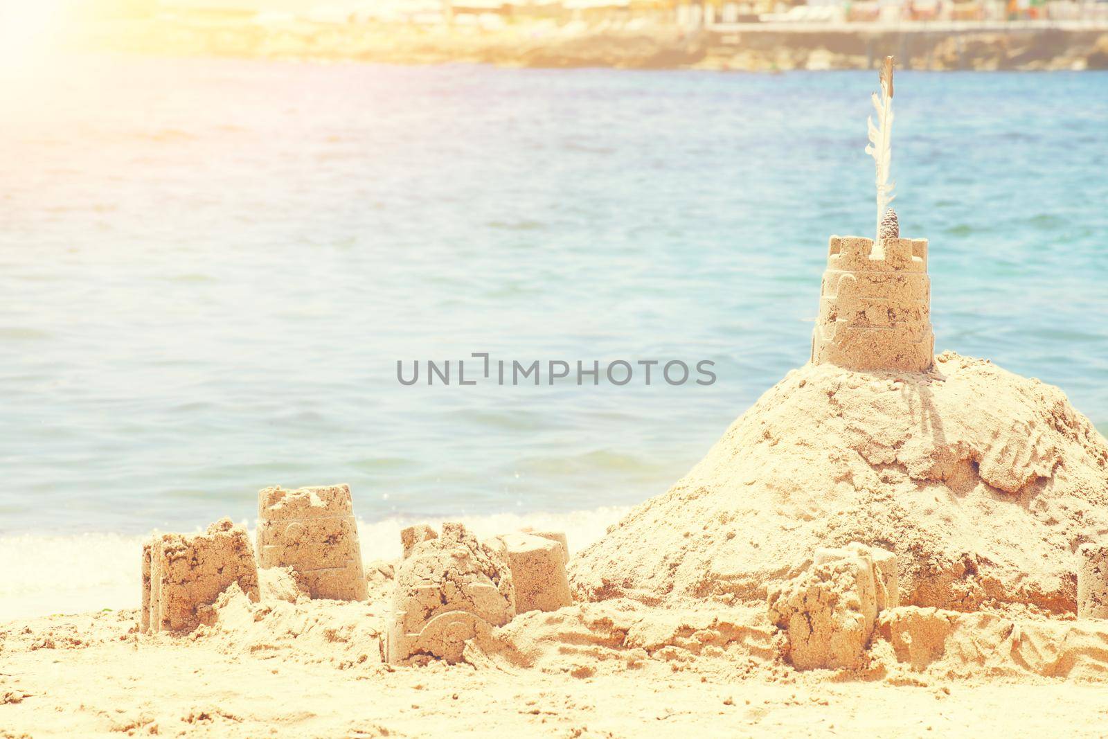 Holiday concept with sandcastle on the seaside.