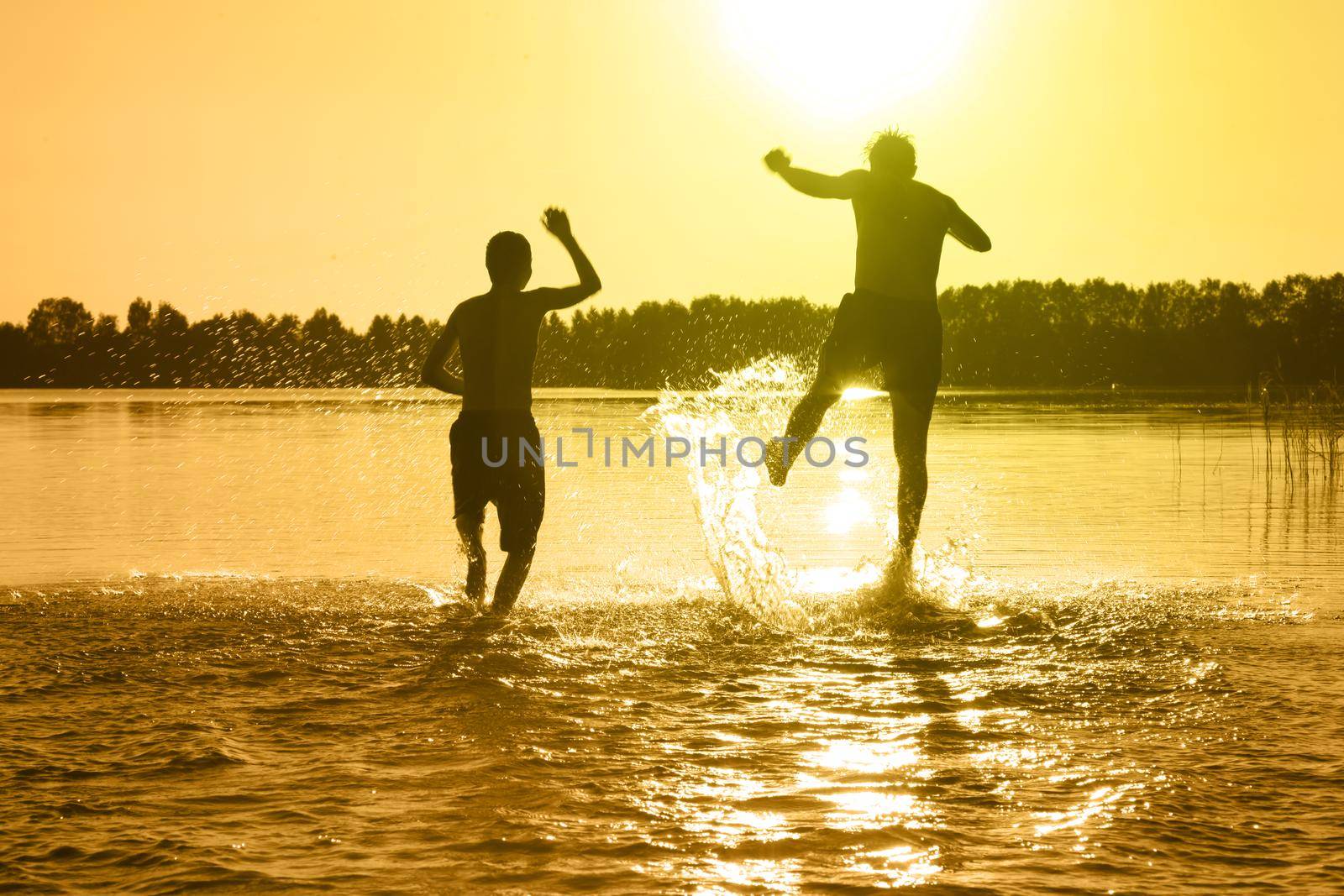 Group of friends having fun on the beach. by Taut