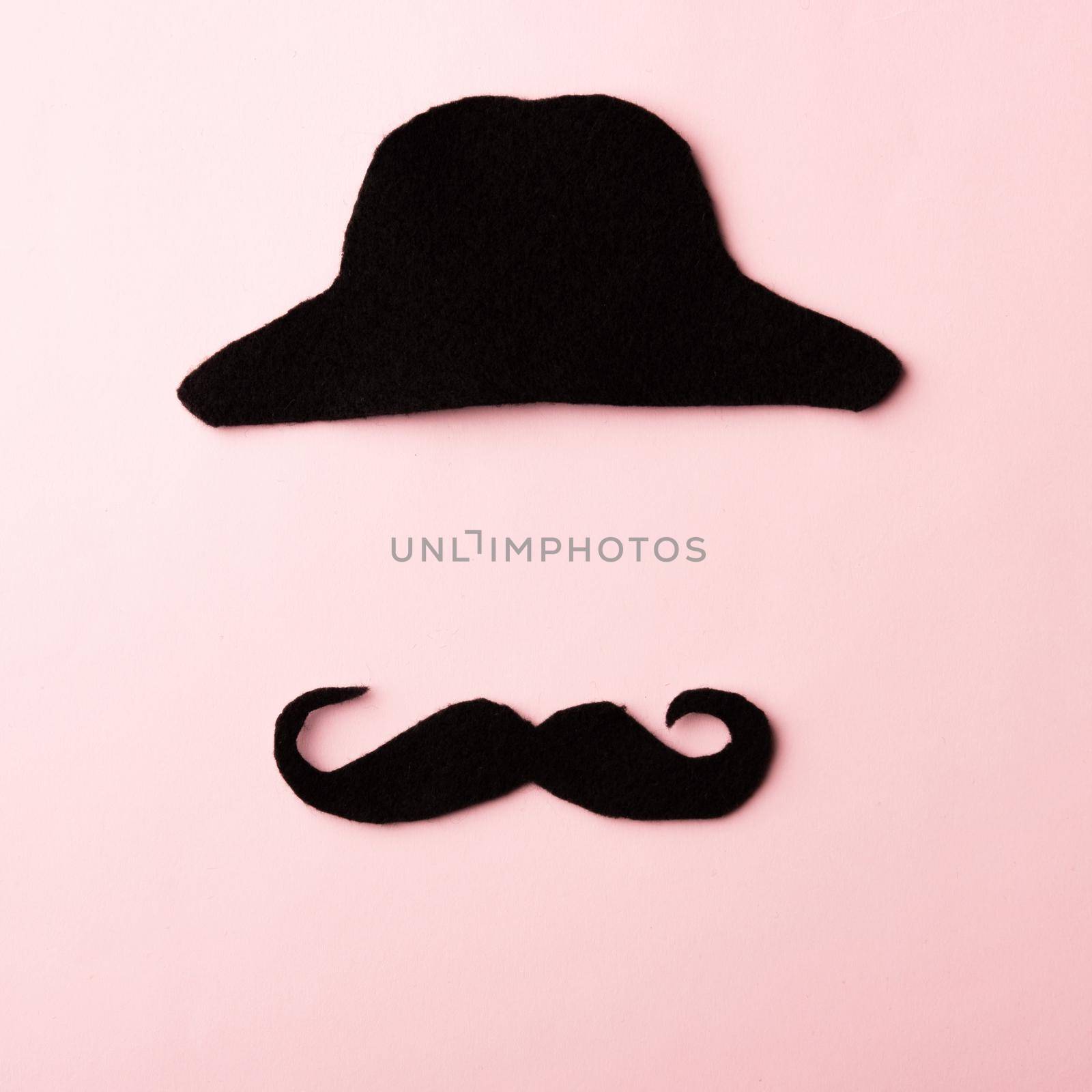 Black mustache and cap, studio shot isolated on pink background, Prostate cancer awareness month, Fathers day, minimal November moustache concept