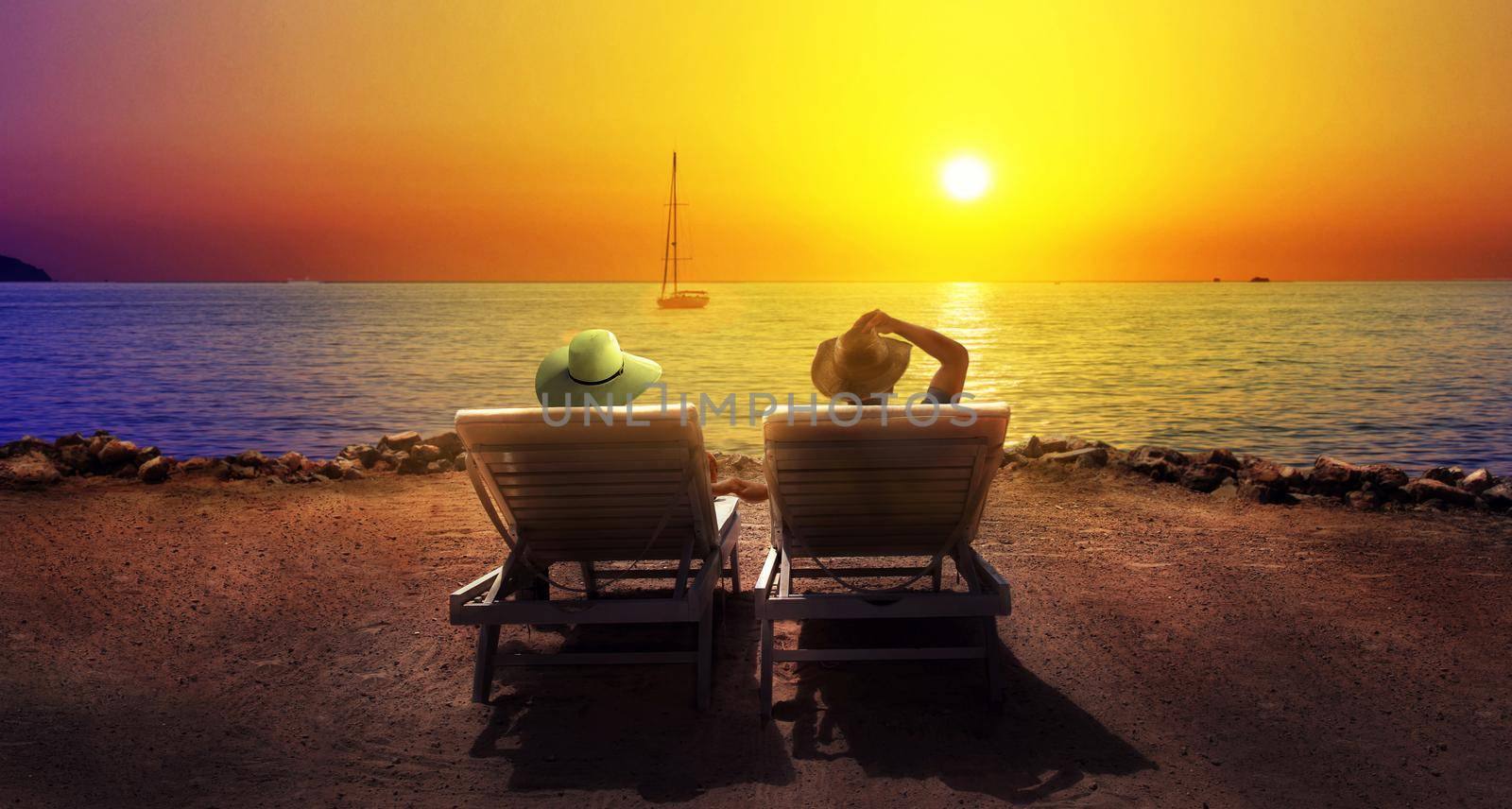 Tourism and travel vacation. Happy couple relaxing in resort on sunset beach. by Taut