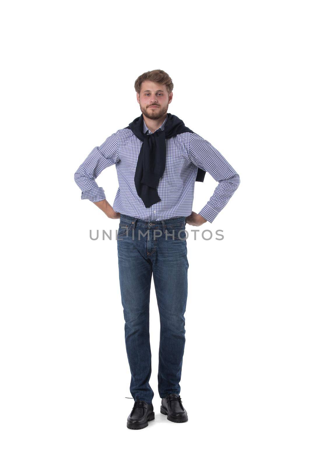 Young man in casual clothes standing isolated over white background with hands on hips