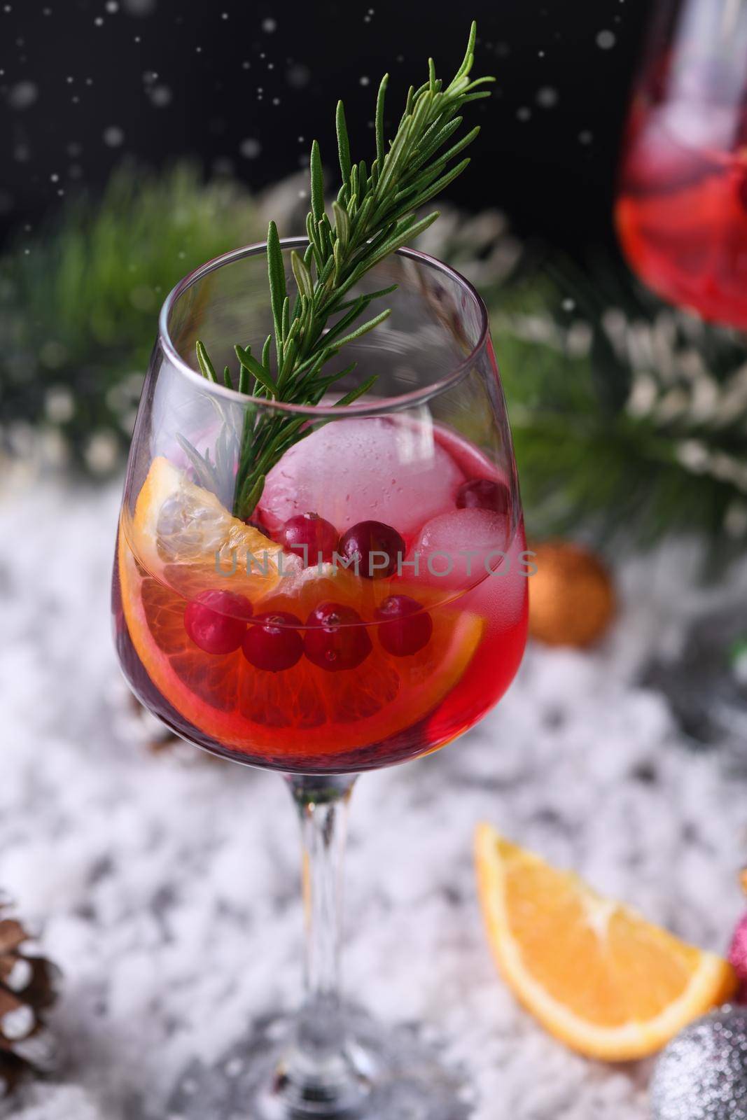 Cocktail Margarita with cranberries, orange and rosemary. A perfect cocktail for a Christmas party