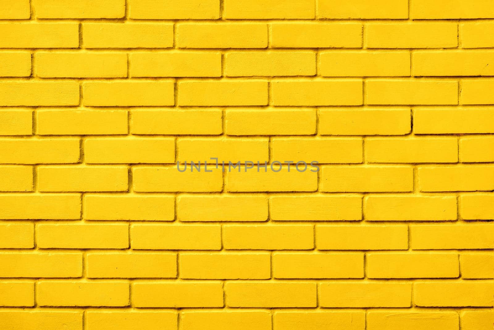 Block texture yellow painted wall brick background warm color. Painted bricks design yellow color wall background blocks. Natural design texture background yellow brick wall color paint block pattern