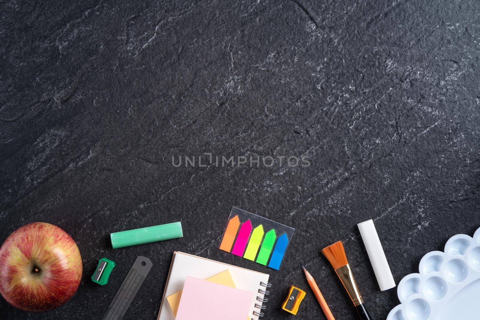 Back to school design concept with stationery over slate black table background. by ROMIXIMAGE