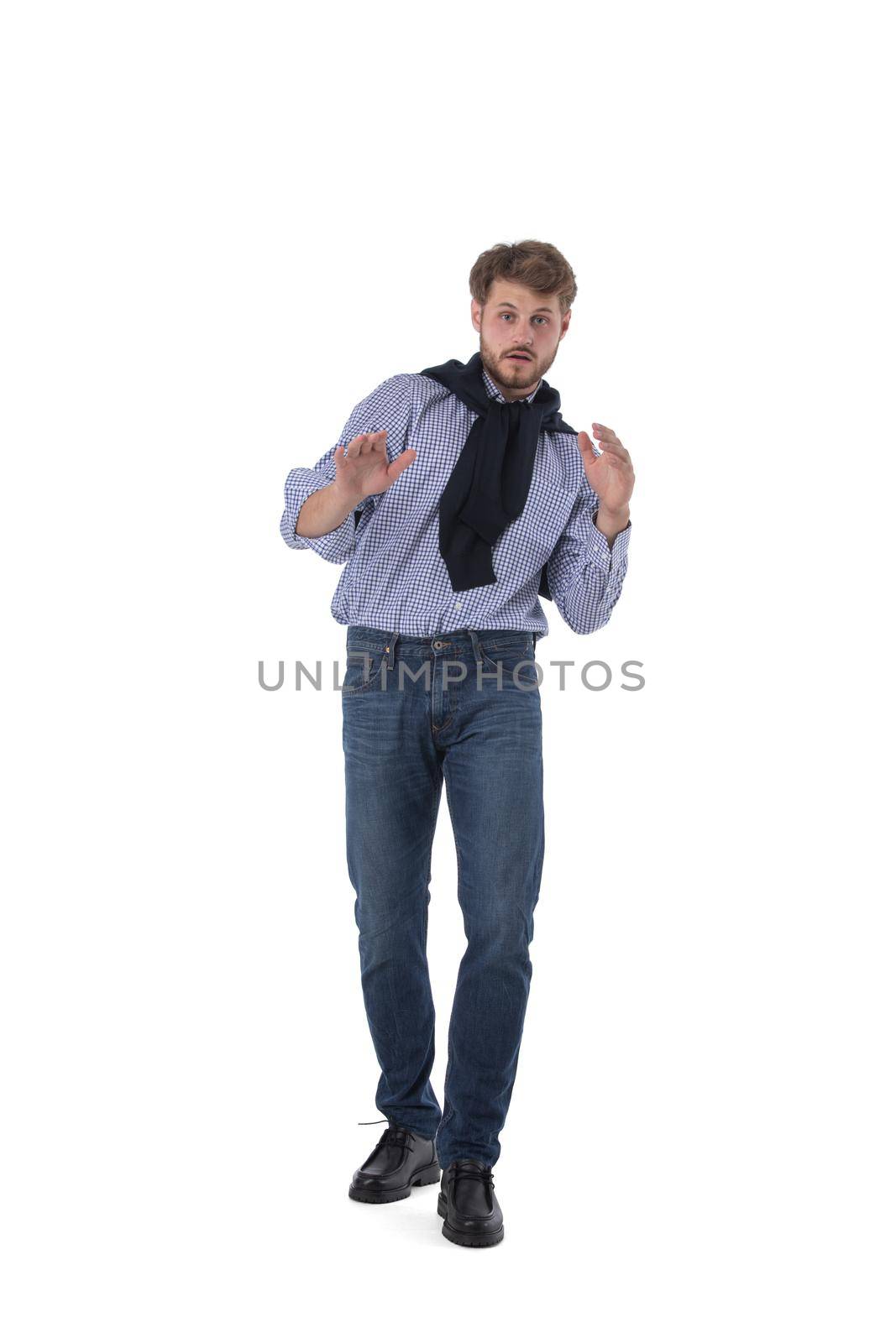 Full length portrait of frightened man stood with a frightened look on his face. Isolated on white background