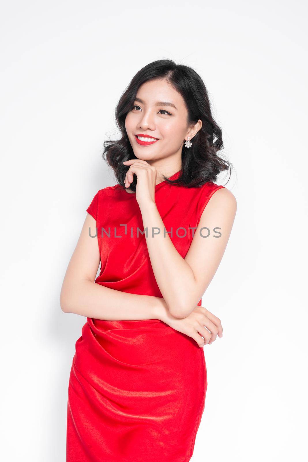 Glamour asian woman in stylish red party dress by makidotvn
