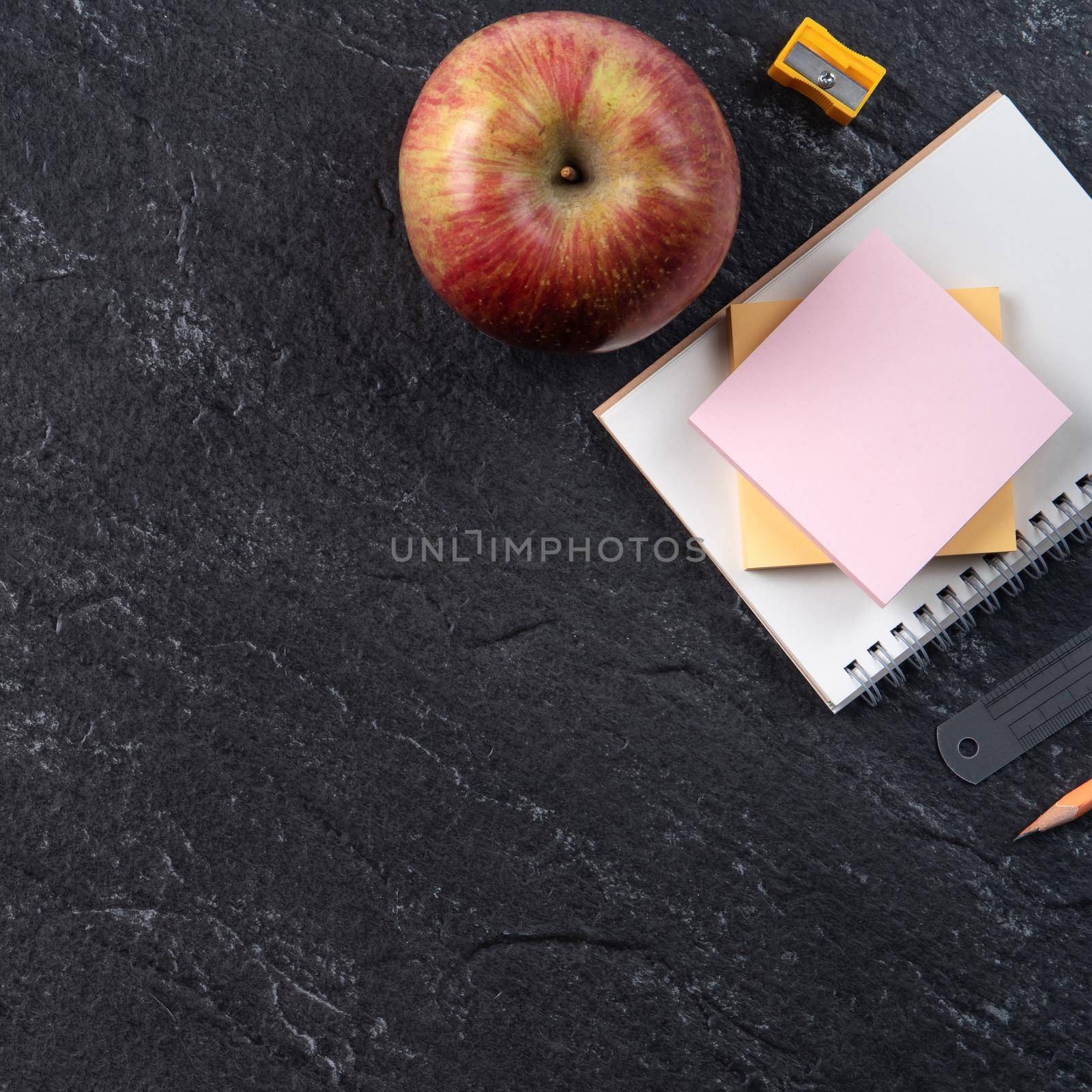 Back to school student design concept, top view of stationery over slate black table background with copy space.