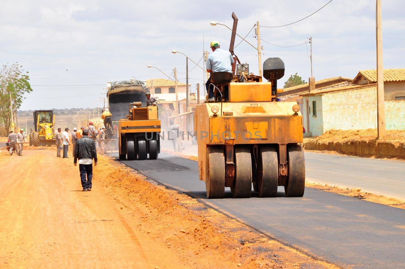 vitoria da conquista, bahia, brazil -  september 15, 2011: Machines and workers are seen doing asphalt resurfacing on an avenue in the city of Vitoria da Conquista.

