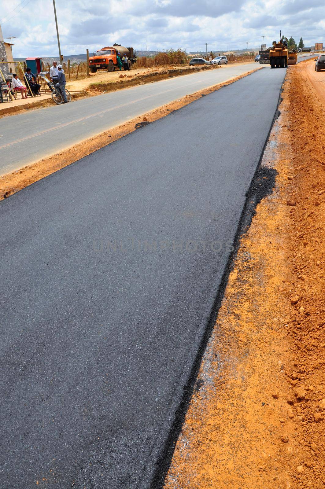 vitoria da conquista, bahia, brazil -  september 15, 2011: Machines and workers are seen doing asphalt resurfacing on an avenue in the city of Vitoria da Conquista.