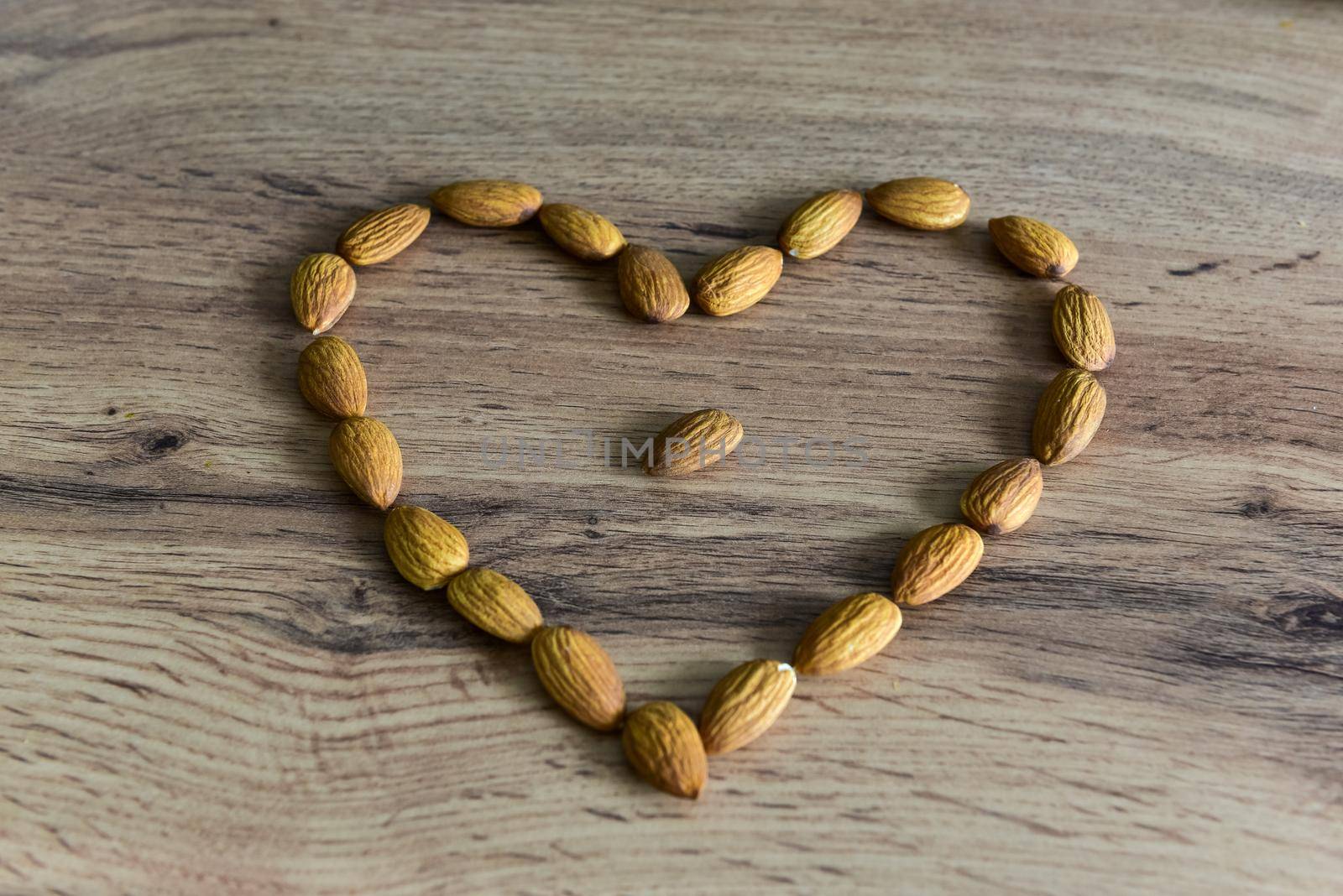 Almonds lying on the table in the form of a heart.