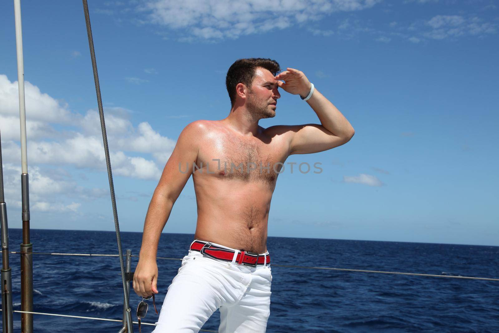 Man enjoying summer time holiday on sailing boat.