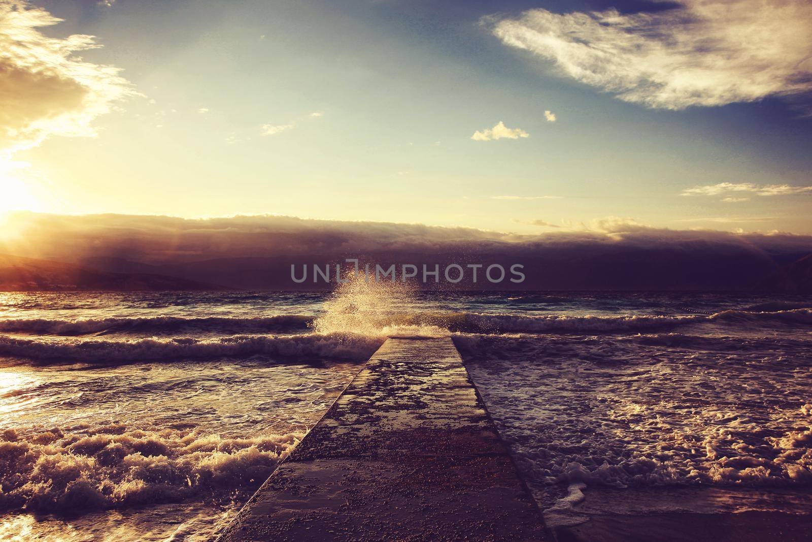Feeling of freedom concept. Big waves beats against the pier.