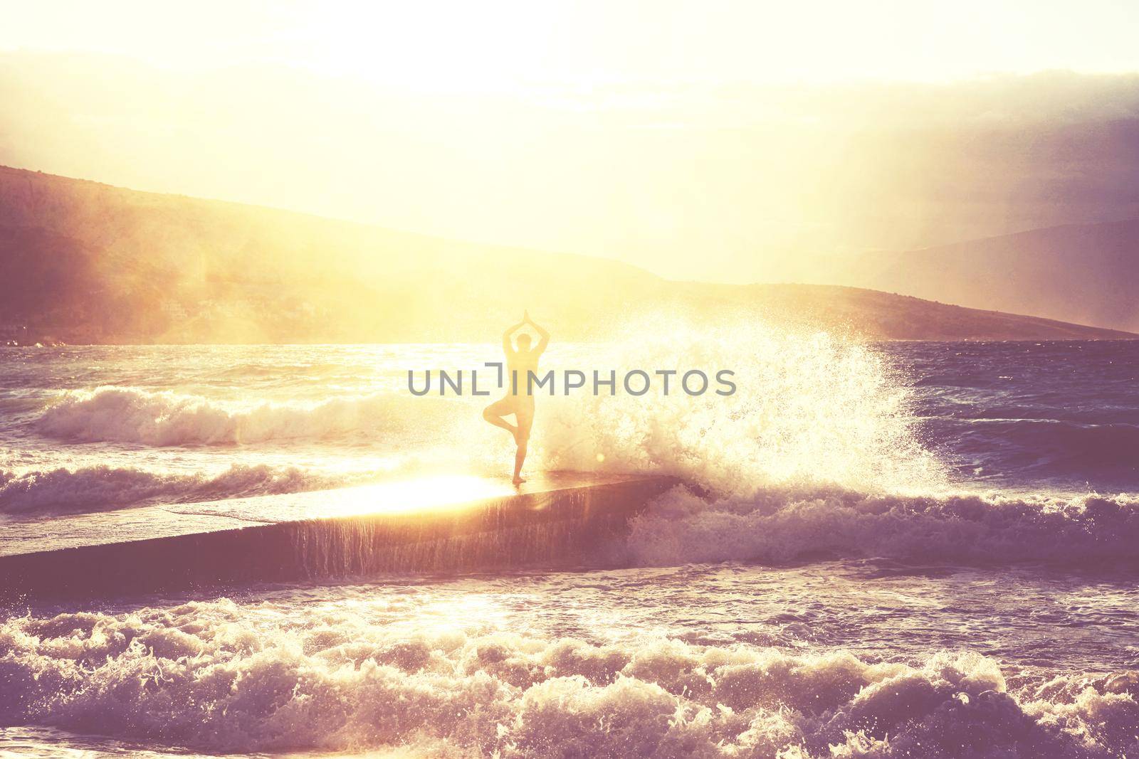 Feeling of freedom concept. Man standing on pier facing to the sea with big waves.