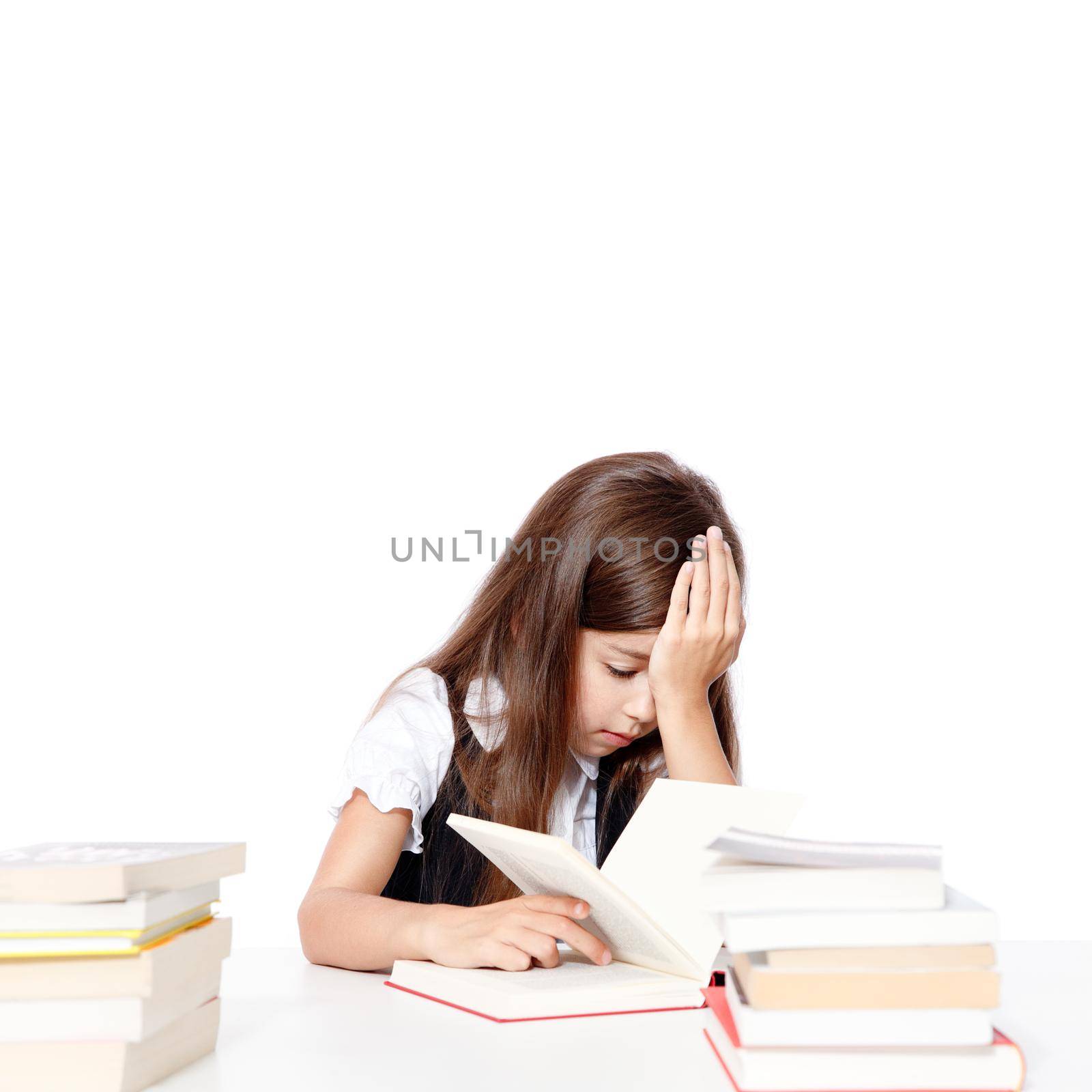 Tired little child girl sleeping on the desk at school. by Taut