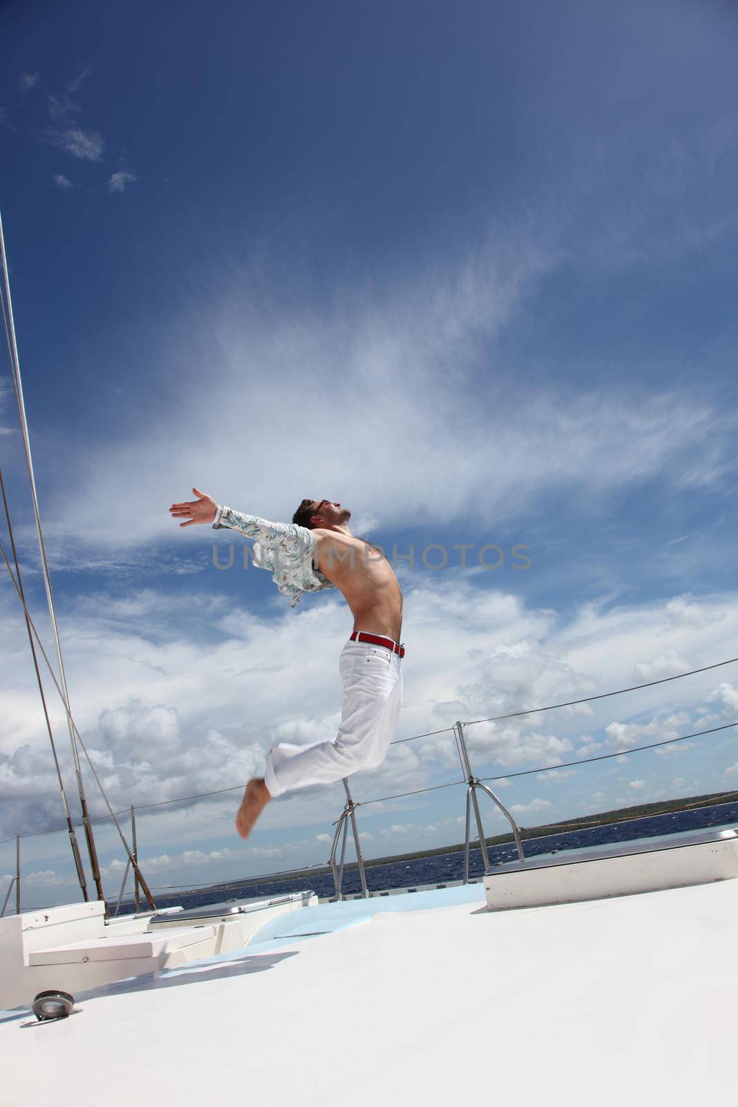 Man enjoying summer time holiday on sailing boat.