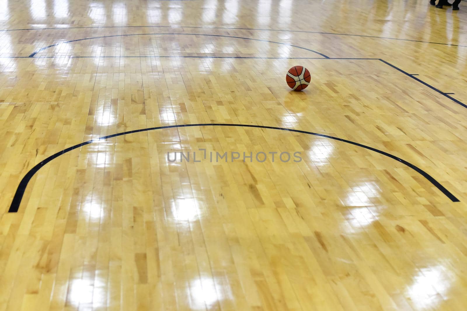 Basketball ball on Court Floor close up with blurred background by karpovkottt