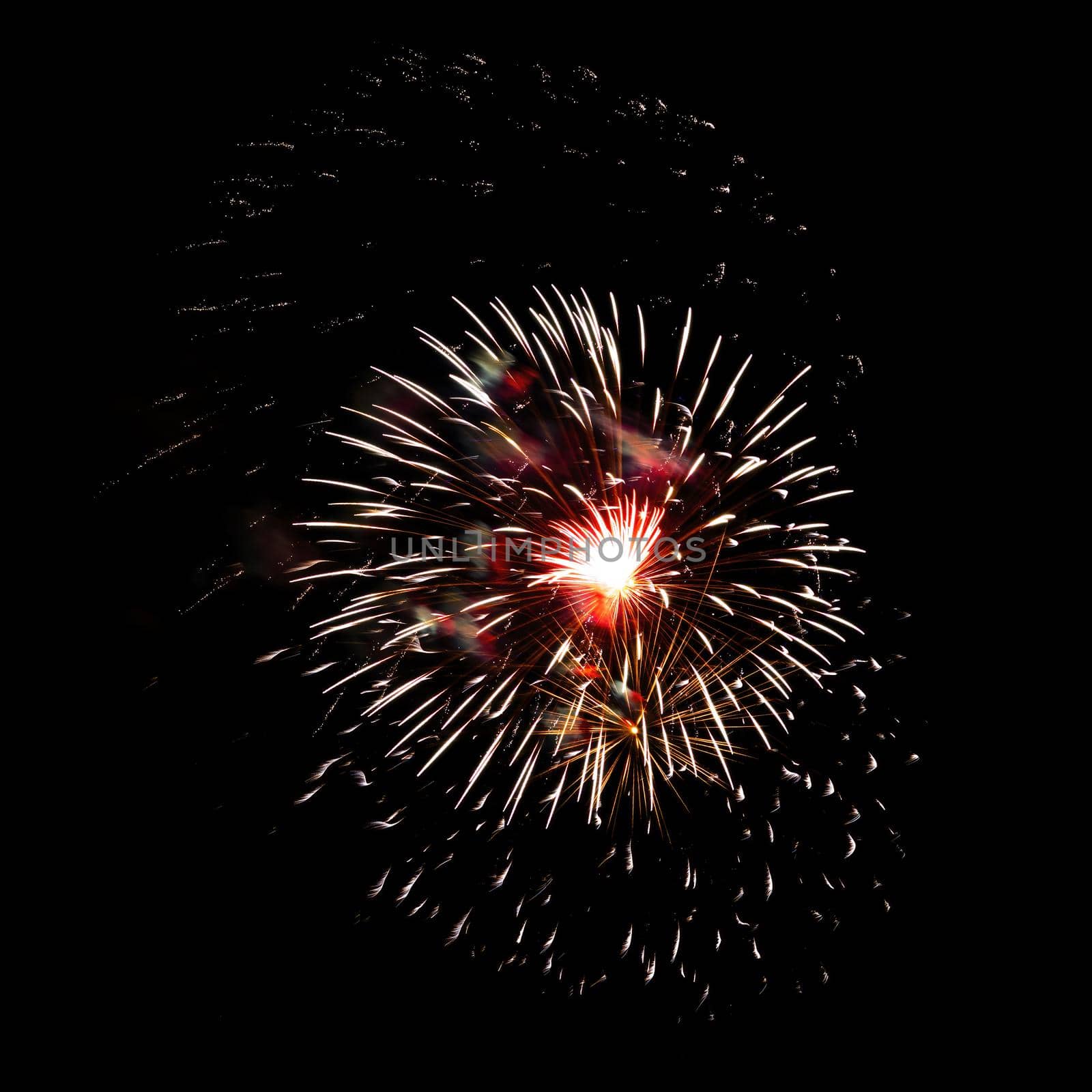 Colorful celebration fireworks isolated on a black sky background.