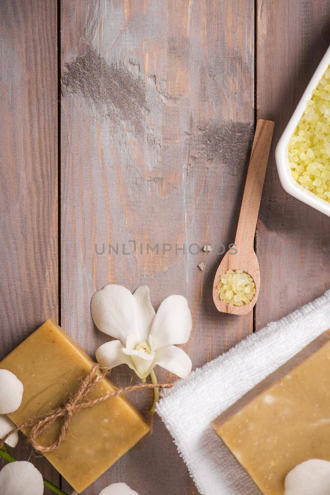 Spa set. Handmade, natural organic soap and white orchid on a wooden background by makidotvn