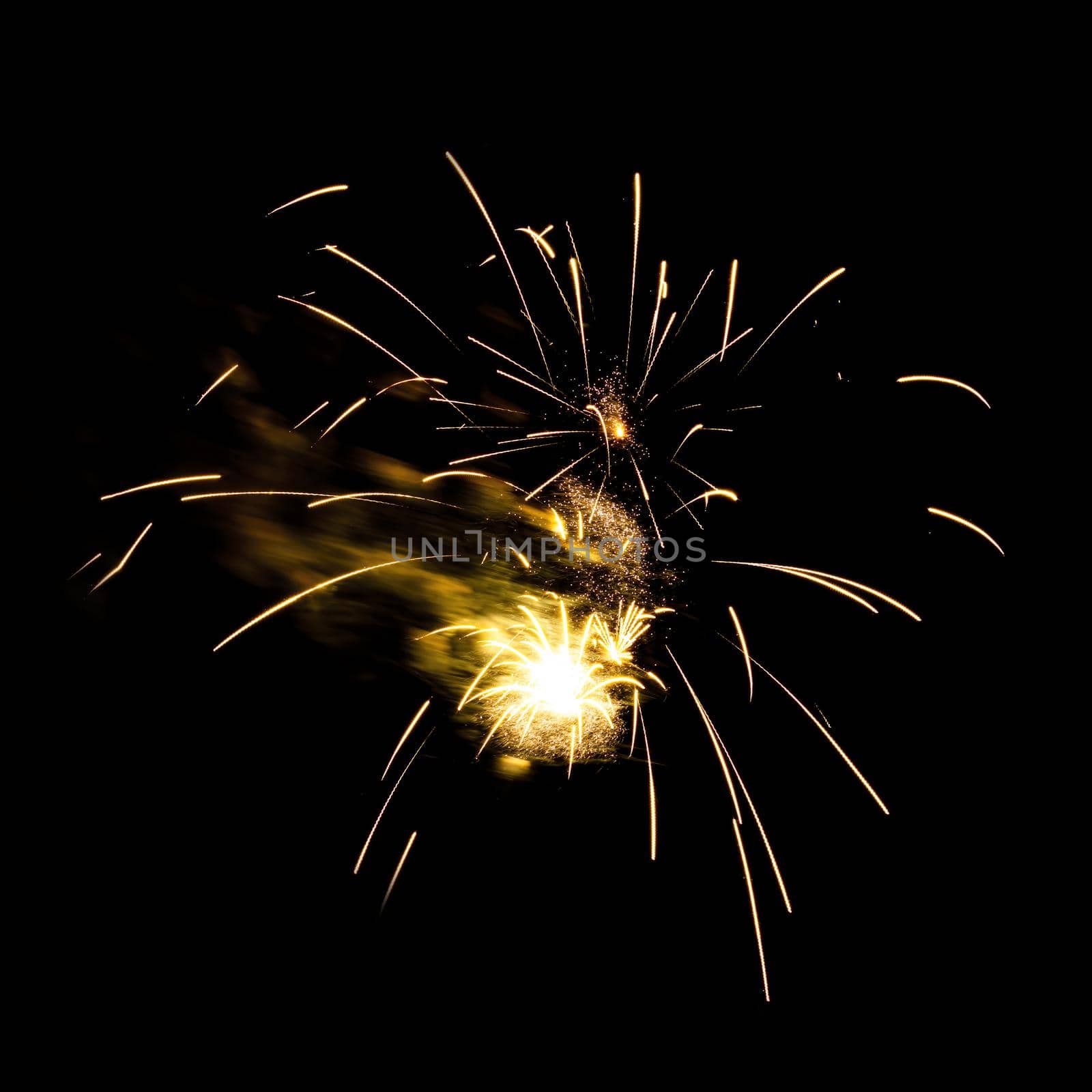 Colorful celebration fireworks isolated on a black sky background.