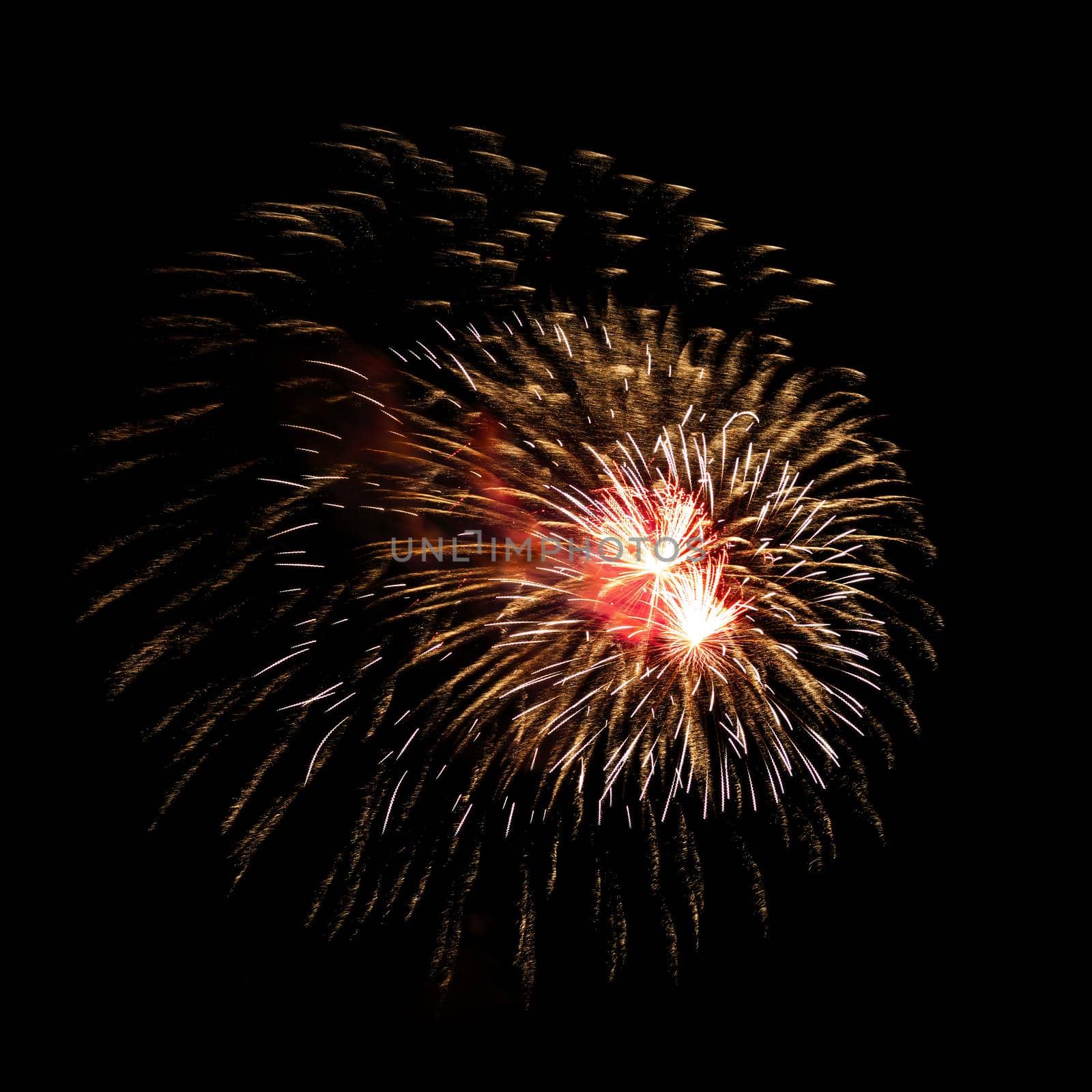 Colorful celebration fireworks isolated on a black sky background.