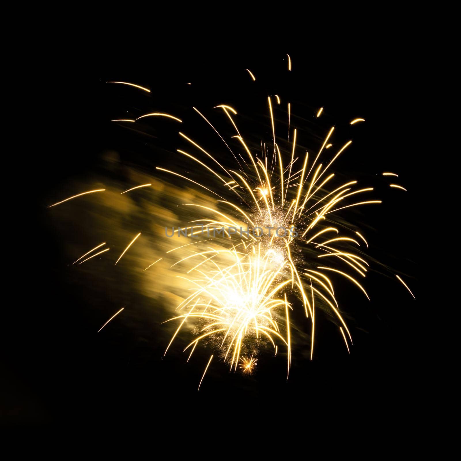 Colorful celebration fireworks isolated on a black sky background.