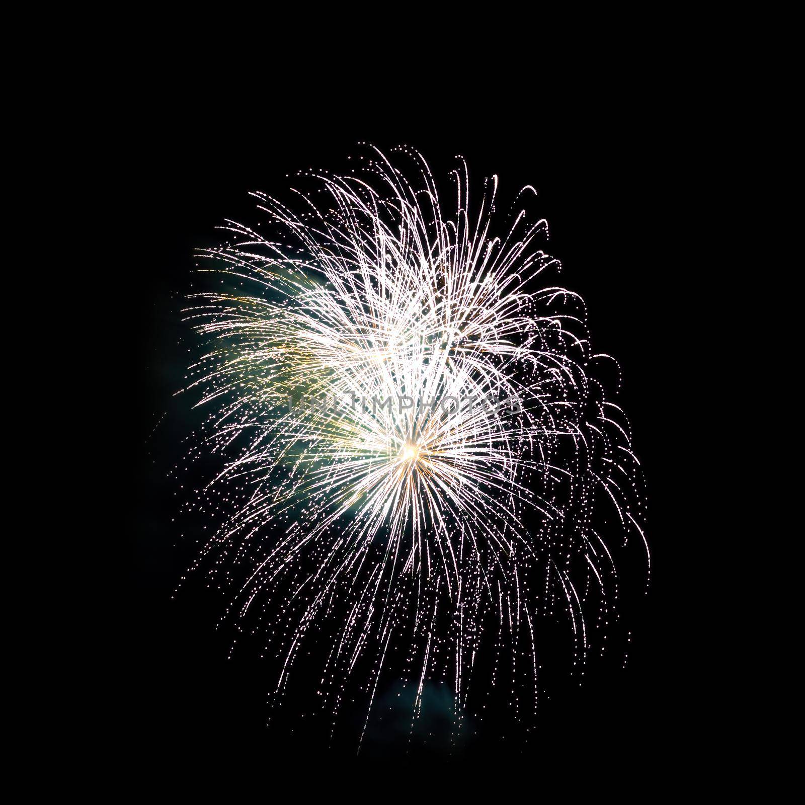 Colorful celebration fireworks isolated on a black sky background.